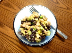 a bowl of two bean salad with a fork