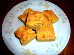 five pieces of corn bread sitting on a plate