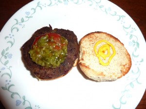 A yummy mushroom burger sitting on a plate.
