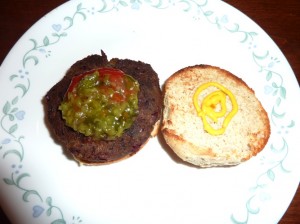 A yummy mushroom burger sitting on a plate.